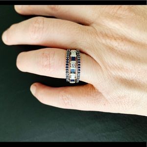 Three stacked diamond and sapphire rings